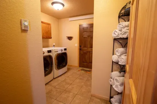 The main level laundry room offers the convenience of washing and drying clothes during your stay, making it easy to keep things fresh throughout your visit.
