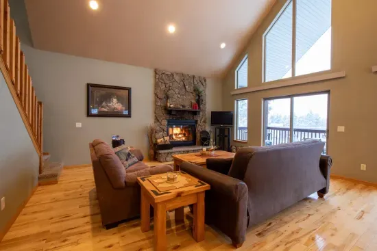 Gather together and take in the stunning views from the main level living room, where large windows frame the natural beauty of the Black Hills.