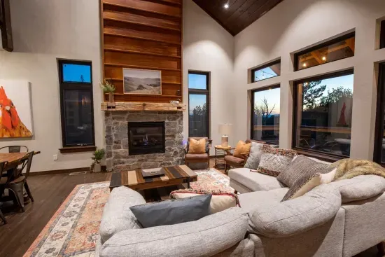 The large living room windows invite the beauty of the Black Hills to join you on the  couch.