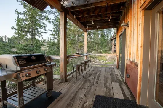 The large deck hosts a natural gas grill and outdoor seating.