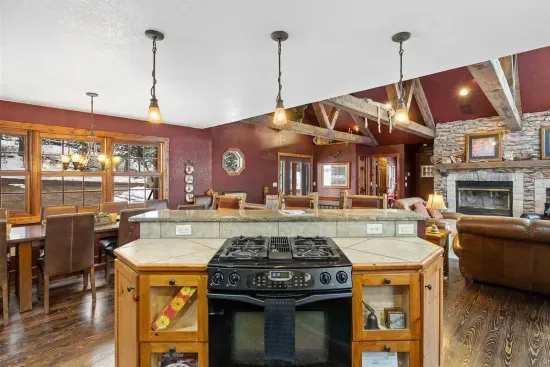 A gas top Jenn-air stove is perfect for cooking up delicious meals.