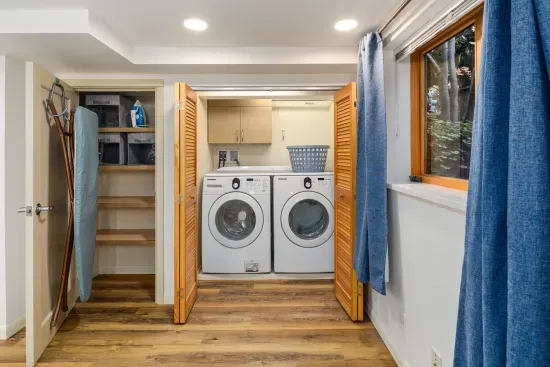 Large washer and dryer, ironing board, iron and generous shelving for personal items