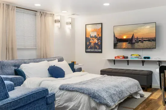 New memory foam mattress on the living room sofa bed with comforter and extra blankets.