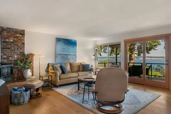 A spacious living with panoramic views.  The wide glass door onto the deck include a little ramp - easy access for folks who may use a walker and a wheelchair.