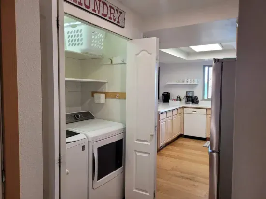 Full washer and full dryer with ironing board and iron, and plenty of laundry free and clear laundry pods
