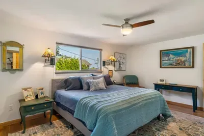 King hybrid mattress and block out blinds with ceiling fan in the main bedroom