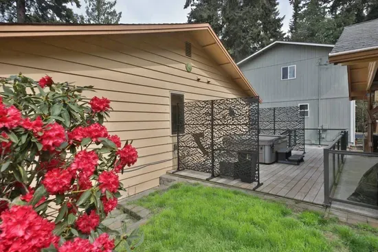 Behind the house, off the carport, is a fenced-in, sunny area with a hot tub for three nearby.   Safe to let your fur baby enjoy the outdoors.