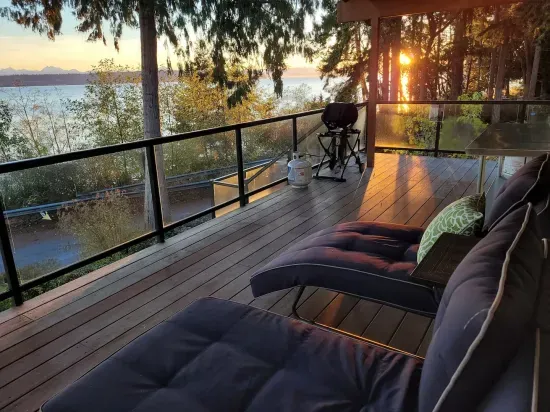 Catch the sunrise while enjoying the panoramic water and mountain views from the adjustable chaise lounges on the covered and heated deck.