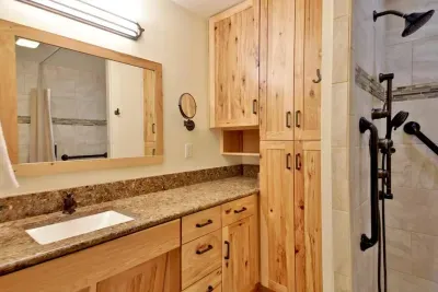 The spacious primary king bedroom features an ensuite bath with a large shower.   Doors to the bedroom and the bathroom allow for ADA access.