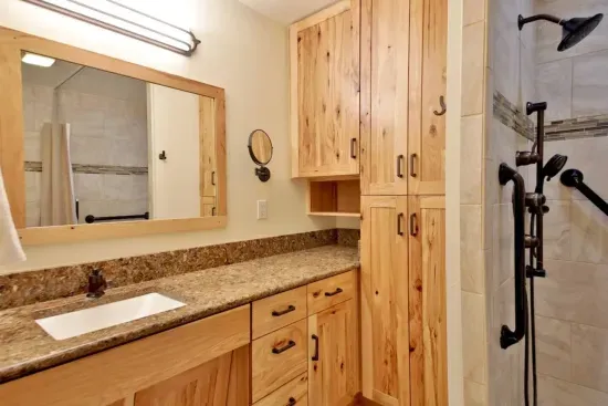 The spacious primary king bedroom features an ensuite bath with a large shower.   Doors to the bedroom and the bathroom allow for ADA access.