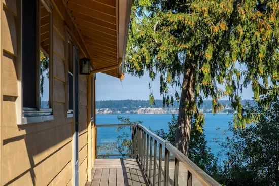 A side door with a coded lock can be accessed from the carport (no stairs) behind the house or from the driveway in front of the house.