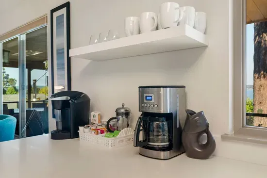 Coffee station with Keurig and Cuisinart coffeemakers and many tea choices.
