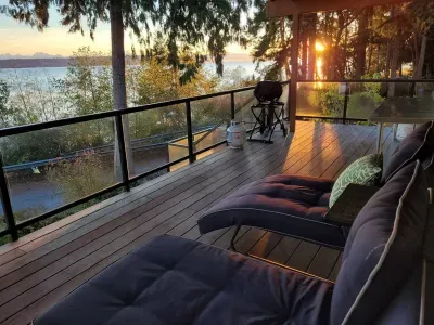 Catch the sunrise while enjoying the panoramic water and mountain views from the adjustable chaise lounges on the covered and heated deck.