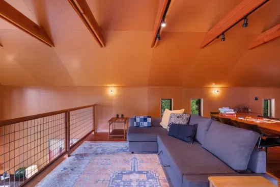 The expansive loft, with its wood-beamed ceilings, features a second day bed and a queen pull out sofa.