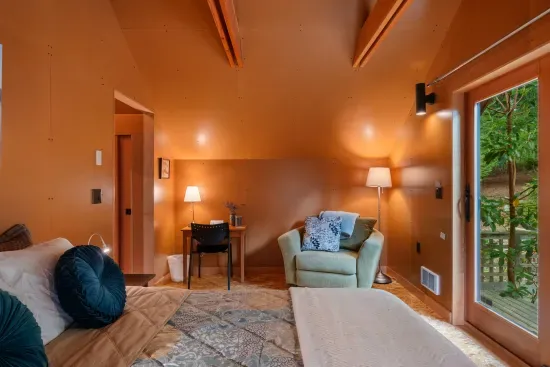 Guests can relax in the reading chair and conveniently set up their laptop on the desk, complete with a side lamp.