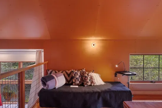 The expansive loft, with its wood-beamed ceilings, features a second day bed and a queen pull out sofa.