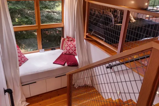 On the stairway leading to the spacious loft, you'll find a daybed perfect for napping, reading, or simply enjoying the view.