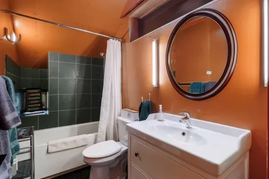 The second floor bathroom features a deep tub and shower.