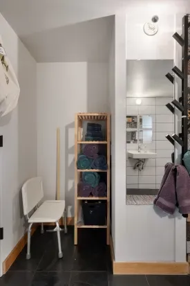 This ADA compliant ground bathroom has a shower chair, a full length mirror, lots of towels, a first aid kit, and plenty of hooks.