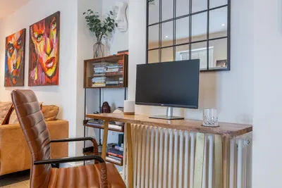 A dedicated desk with an external monitor and fast WiFi — a proper setup for remote work, not a laptop balanced on your knees. Soho's cafés are downstairs when you need a change of scene.