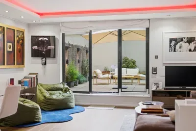 Living Room Oasis: Enjoy vibrant art, plush seating, and serene patio views through expansive windows!