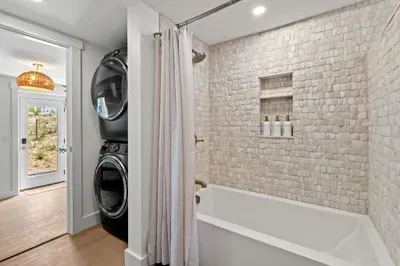 Spa-style bath with soaking tub and in-unit washer/dryer