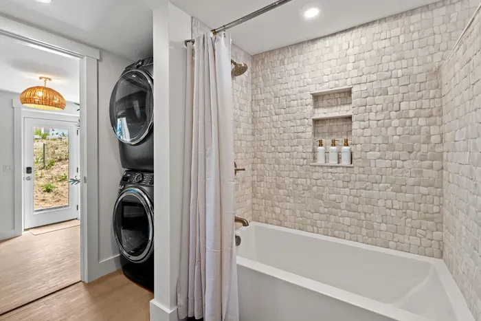 Spa-style bath with soaking tub and in-unit washer/dryer