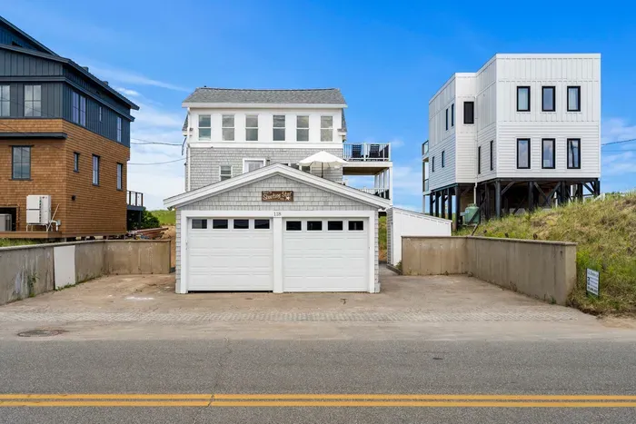 Coastal home with 2-car garage, spacious parking, and bright beach-house charm