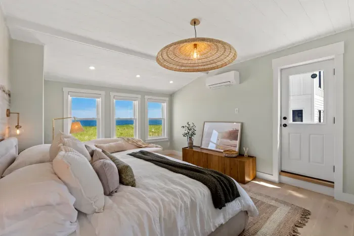 Bright coastal bedroom with ocean views and a plush, serene design