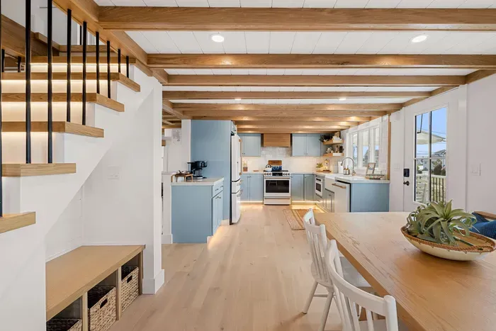 Bright coastal kitchen with exposed beams and airy open dining space