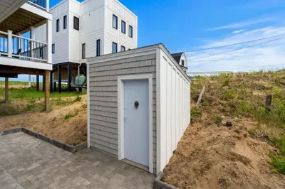 Convenient outdoor storage and patio space beneath this elevated beach home