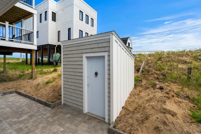 Convenient outdoor storage and patio space beneath this elevated beach home