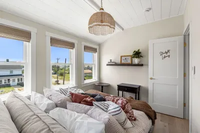 Sunny, cozy bedroom with plush bedding and charming designer touches