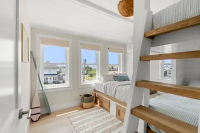Sunny beachy bunk room with built-in beds and stylish coastal charm