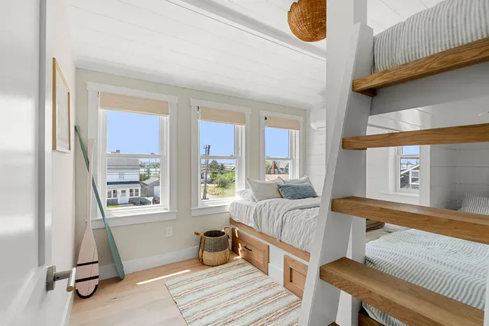 Sunny beachy bunk room with built-in beds and stylish coastal charm