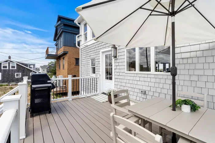 Private sunny deck with grill and shaded outdoor dining