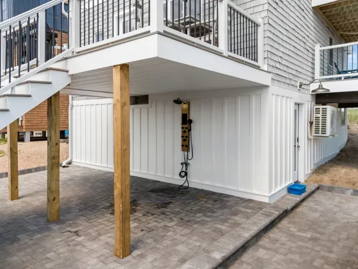 Covered patio with outdoor shower and easy beach-day rinse-off