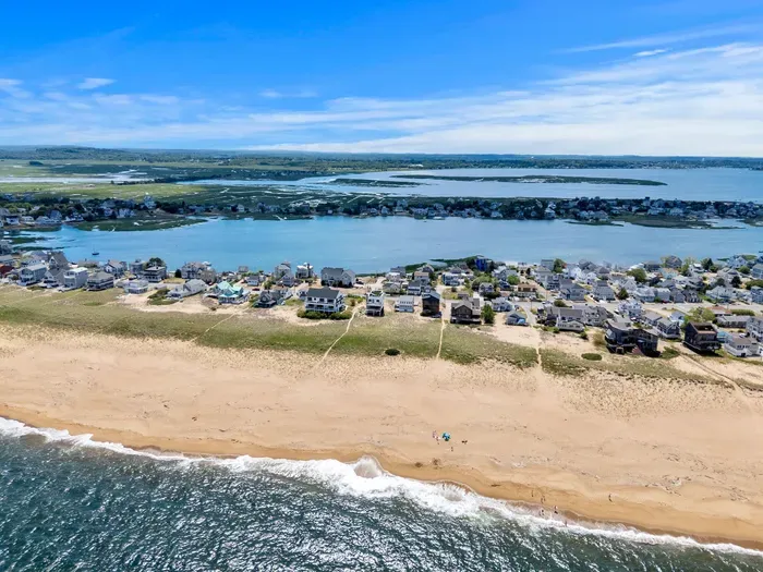 Wide sandy beach and stunning ocean-to-bay views from this coastal retreat