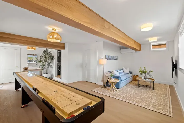 Bright rec room with shuffleboard, cozy lounge, and stylish modern decor