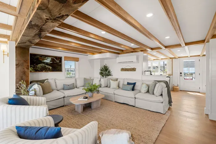 Bright open living room with rustic beams and oversized sectional seating