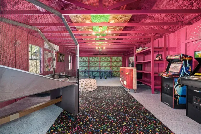 Game room with a ping pong table, arcade games, basketball, darts.