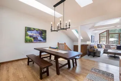 Dining room and stairs down to the front door. Enjoy the peaceful waterfall photo from inside Rocky Mountain National Park while sipping your morning coffee and enjoying your meals!