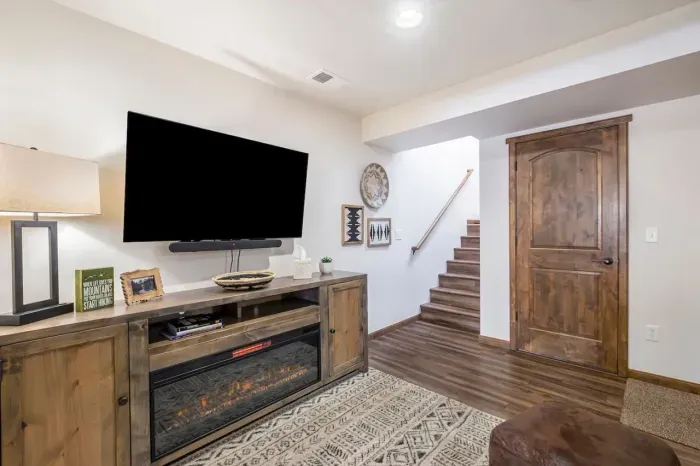 55" smart tv to stream your favorite shows. Kids toys are in the cabinets.