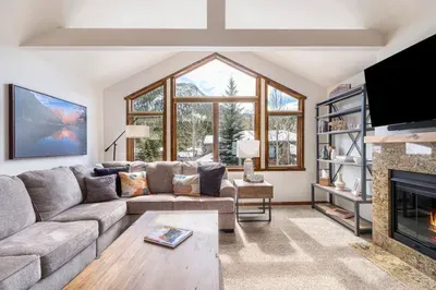 Inviting Living Room looking out to the picturesque mountains, aspens, and evergreens.