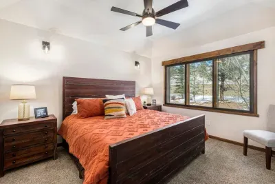 The Primary suite is located on the upper/main level. It has a king-size bed with a memory foam mattress, noise-reducing window panels, a ceiling fan, and black-out shades.