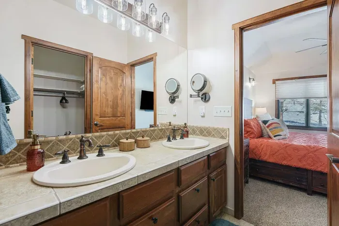A lighted makeup mirror, basic cosmetic supplies, emergency feminine hygiene products, a hairdryer, pump shampoo/conditioner, and soaps are provided.