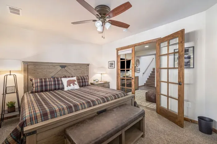 Bedroom 2 has a king-size bed, memory foam mattress, ceiling fan, & french doors with privacy shades.