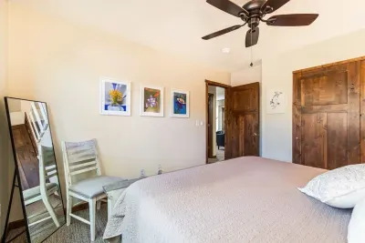 Guest bedroom # 2 in the lower level with a king size bed and full length mirror.