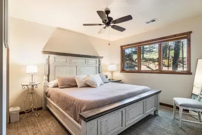 Guest bedroom # 2 in the lower level with a king size bed and ceiling fan.