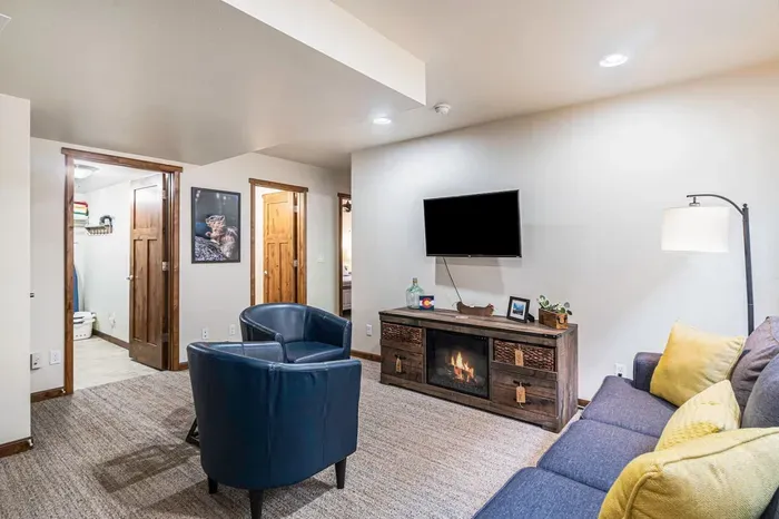 Lower level family room with smart TV and electric fireplace.